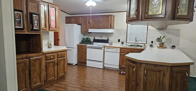 a kitchen with stainless steel appliances a sink a stove a refrigerator and cabinets