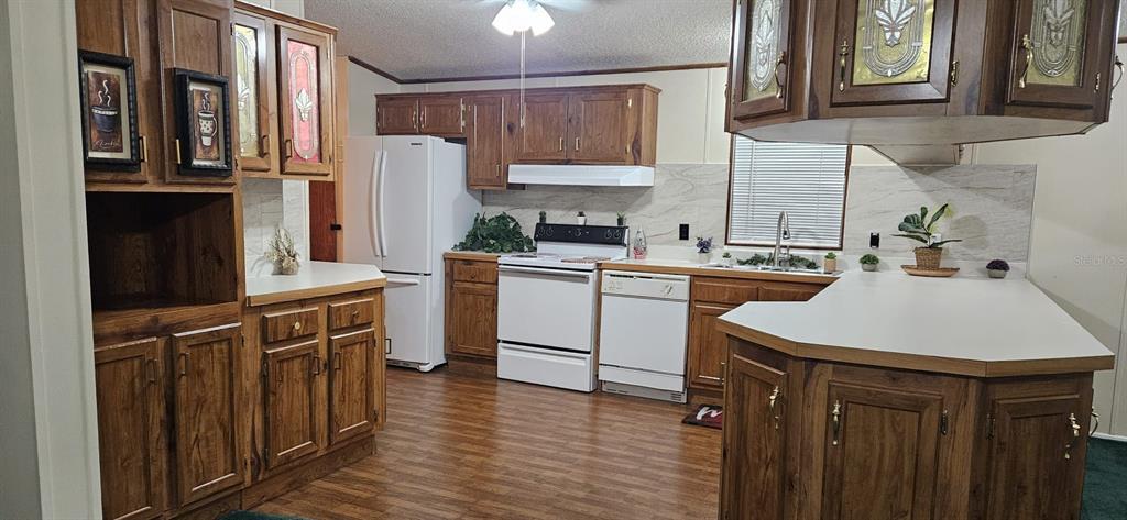 3636 South Lazy Lake Drive Lakeland, FL 33801 - Photo 4 of 28 a kitchen with stainless steel appliances a sink a stove a refrigerator and cabinets
