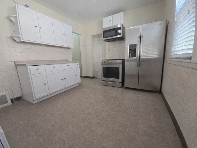 a view of a kitchen with a sink dishwasher and a fireplace
