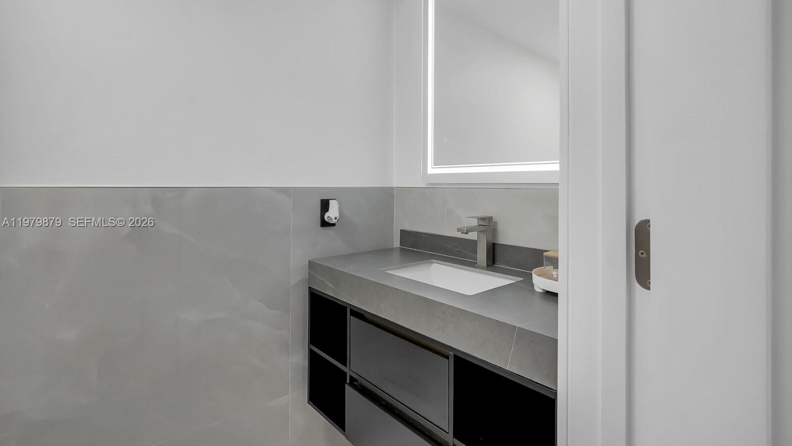 3251 Inverrary Boulevard West Lauderhill, FL 33319 - Photo 11 of 45 1/2 bath downstairs in hallway to garage