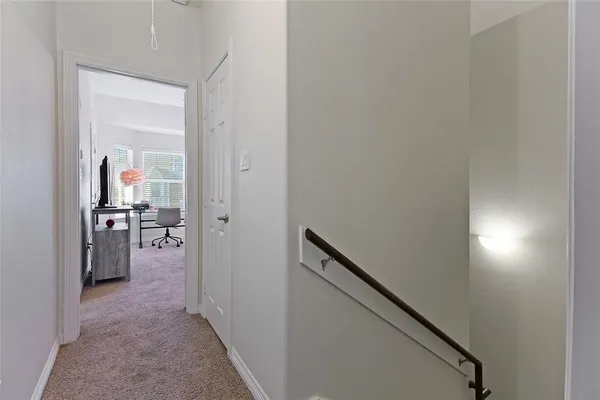 a view of a hallway with a livingroom and a hallway