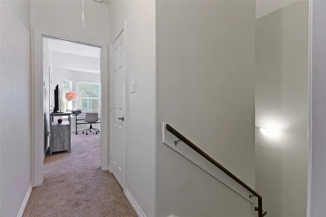 a view of a hallway with a livingroom and a hallway