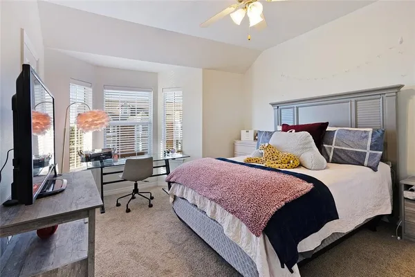 a bedroom with bed and large windows