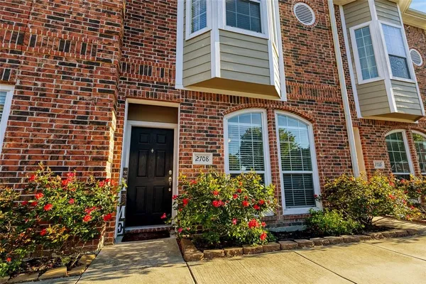 front view of a brick house with a large window