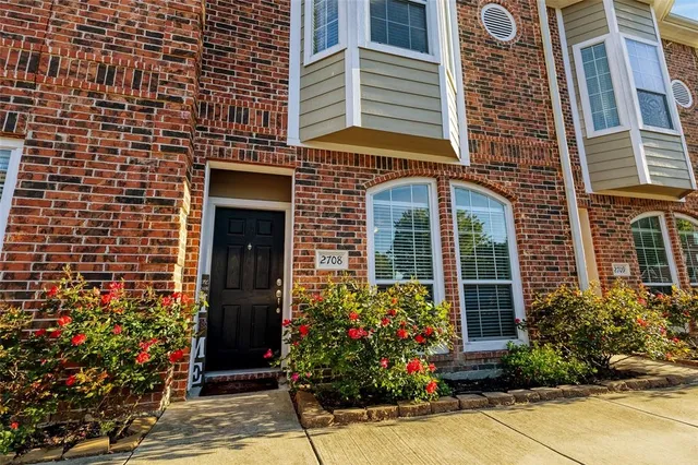 front view of a brick house with a large window