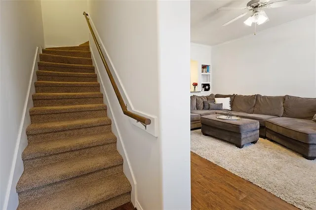 a living room with furniture and a stair