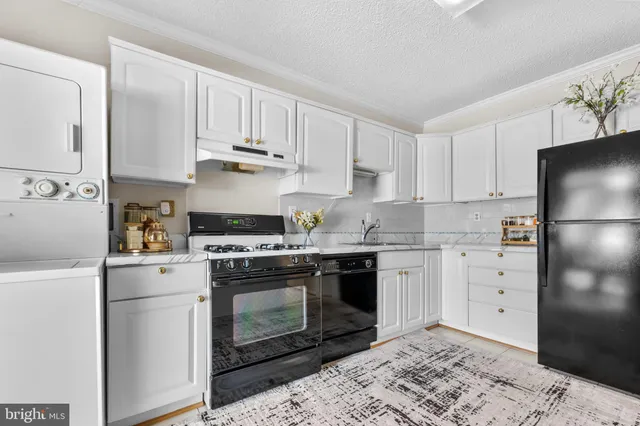 a kitchen with cabinets appliances and a counter space