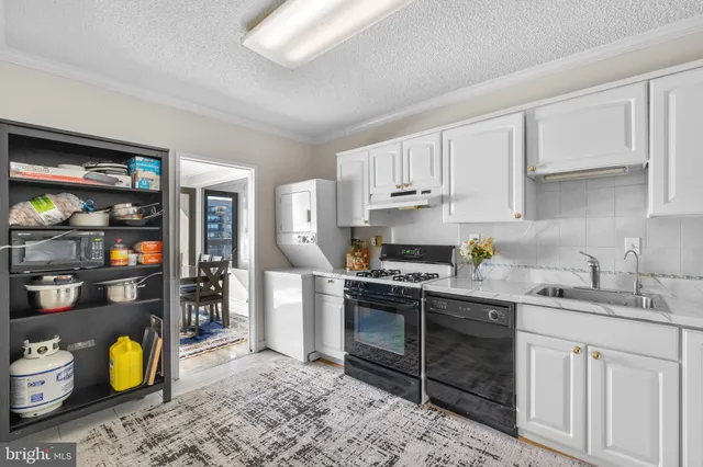 a kitchen with a sink and wooden cabinets