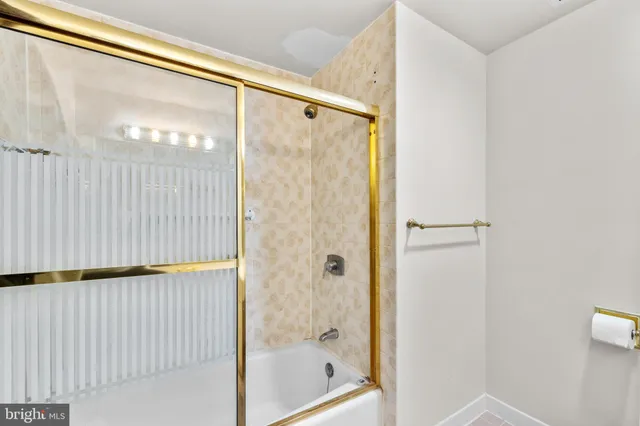 a bathroom with a glass shower door