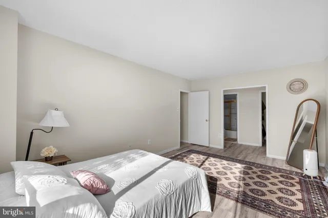 a bedroom with a bed and a lamp