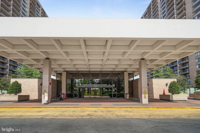 a view of a patio with a table and chairs next to a yard