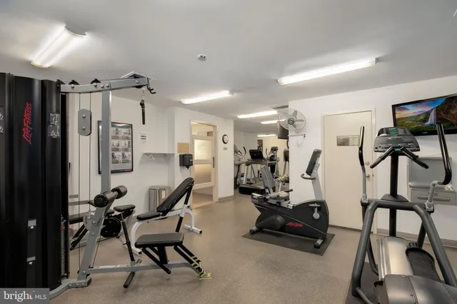 a gym room with lots of gym equipment