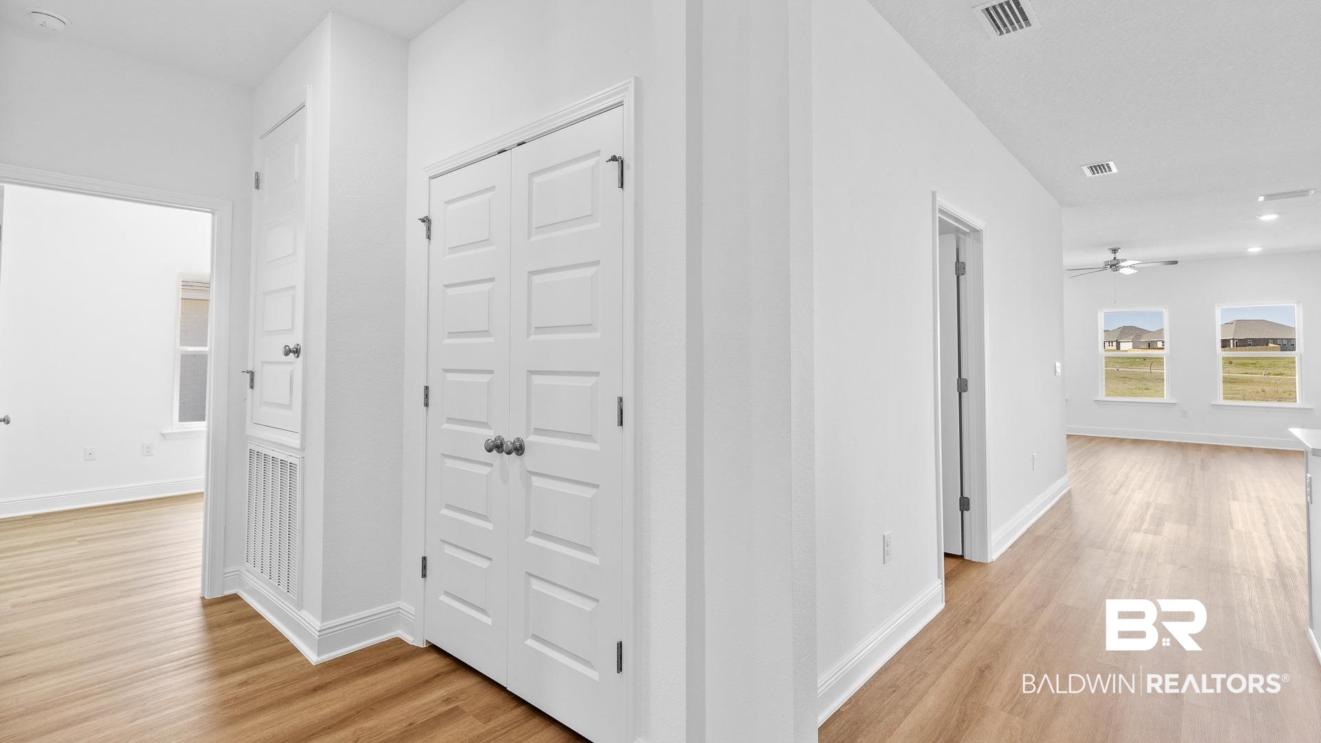 12931 Grand Rpds Road Fairhope, AL 36532 - Photo 10 of 33 Hall featuring visible vents, baseboards, and light wood finished floors