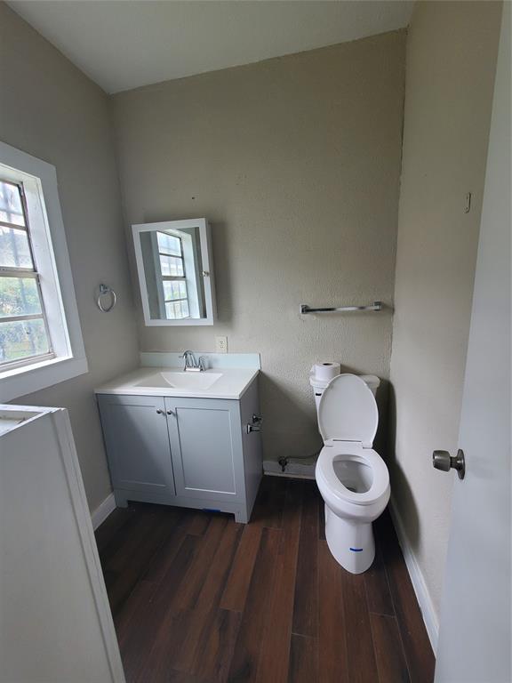 401 North Moore Street Dallas, TX 75203 - Photo 3 of 8 a bathroom with a toilet sink and mirror