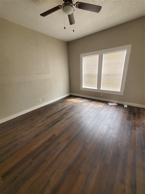 401 North Moore Street Dallas, TX 75203 - Photo 4 of 8 a view of an empty room with wooden floor and a window