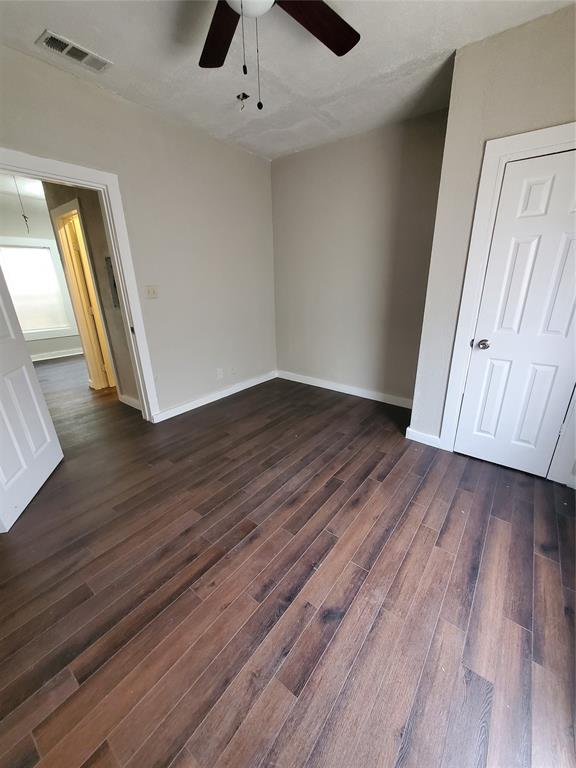 401 North Moore Street Dallas, TX 75203 - Photo 5 of 8 an empty room with wooden floor and windows