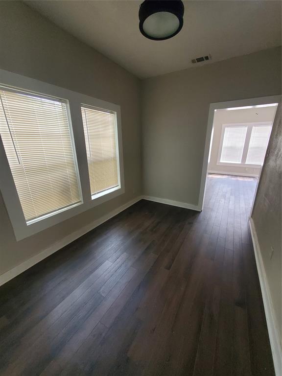 401 North Moore Street Dallas, TX 75203 - Photo 6 of 8 a view of an empty room with wooden floor and a window