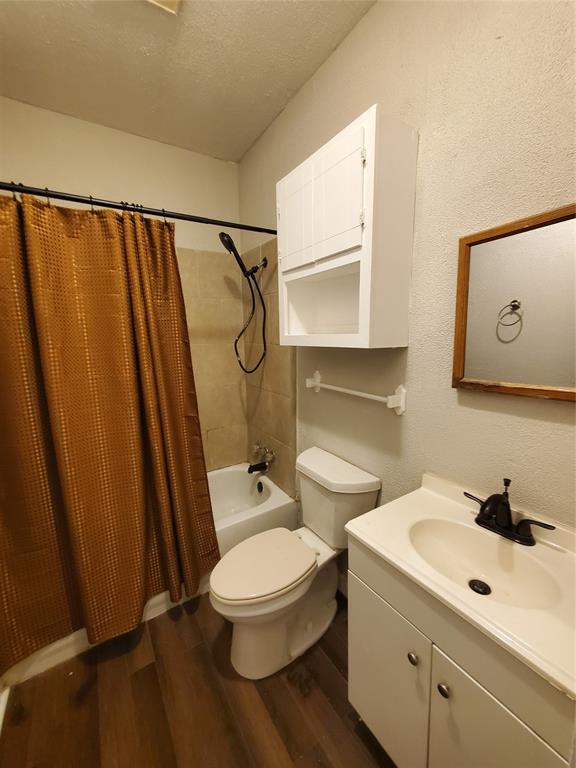 401 North Moore Street Dallas, TX 75203 - Photo 7 of 8 a white toilet sitting next to a bathroom sink