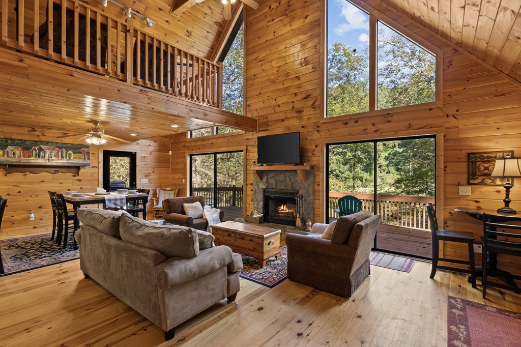 96 Holiday Court Ellijay, GA 30540 - Photo 13 of 51 a living room with fireplace furniture and a large window