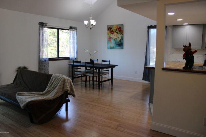 3318 Windermere Drive Bushkill, PA 18324 - Photo 14 of 35 a living room with furniture a dining table and a window