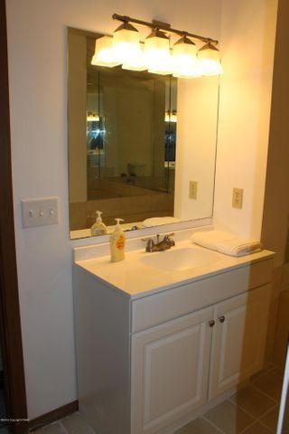 3318 Windermere Drive Bushkill, PA 18324 - Photo 29 of 35 a bathroom with a sink and a mirror