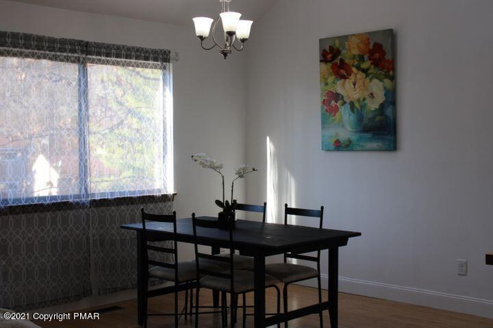 3318 Windermere Drive Bushkill, PA 18324 - Photo 10 of 35 a view of a dining room with furniture window and wooden floor