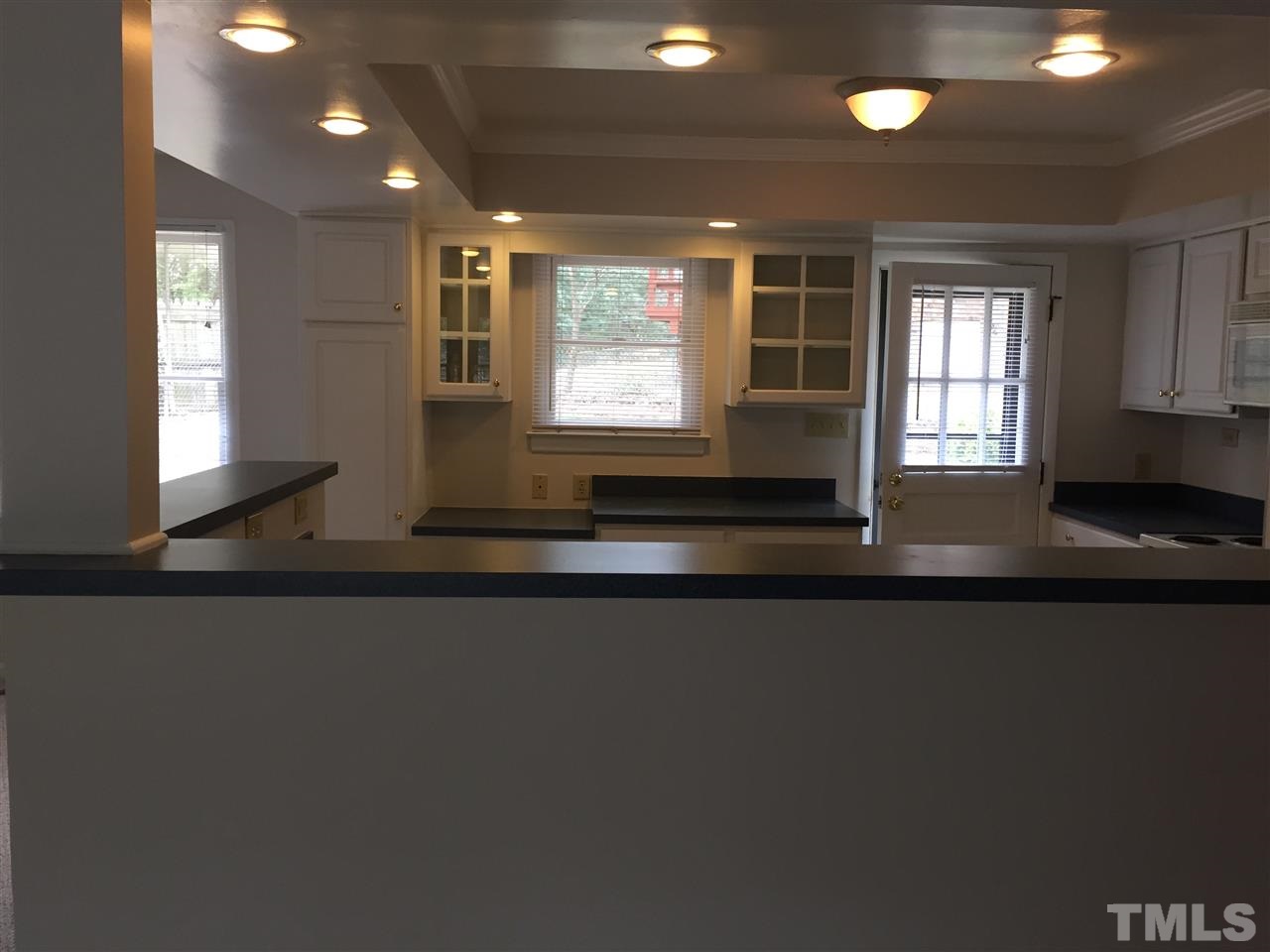 909 Hardimont Road Raleigh, NC 27609 - Photo 3 of 9 a living room with stainless steel appliances wooden floor a large window and a sink