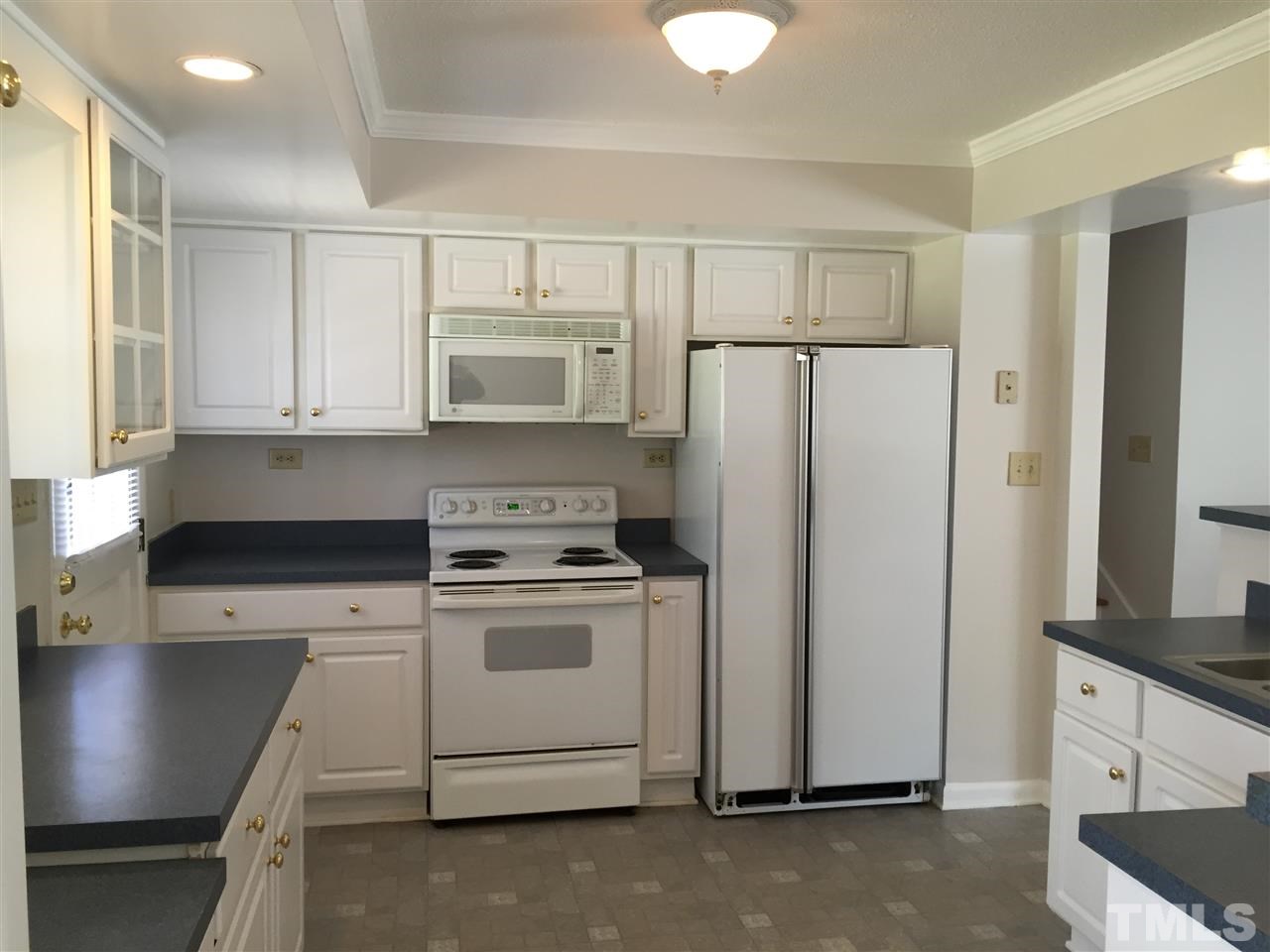 909 Hardimont Road Raleigh, NC 27609 - Photo 5 of 9 a kitchen with stainless steel appliances a refrigerator stove and microwave
