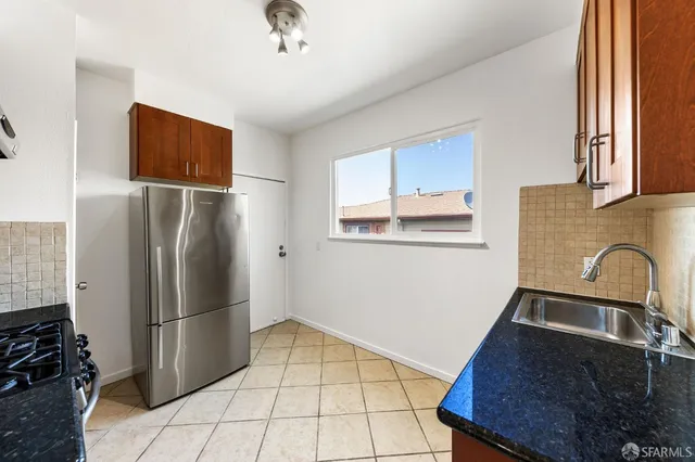 a kitchen with stainless steel appliances granite countertop a refrigerator stove and microwave