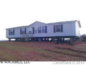 1 Pea Ridge Road Mill Spring, NC 28756 - Photo 1 of 4 a view of a house with a yard
