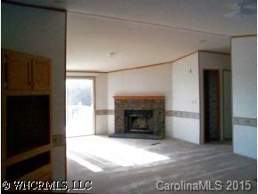 1 Pea Ridge Road Mill Spring, NC 28756 - Photo 3 of 4 a view of empty room with a fireplace