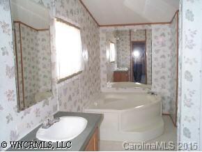 1 Pea Ridge Road Mill Spring, NC 28756 - Photo 4 of 4 a bathroom with a sink and a mirror