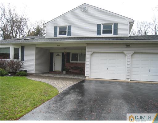 7 Butler Road Edison, NJ 08820 - Photo 1 of 18 a front view of a house with a yard and garage