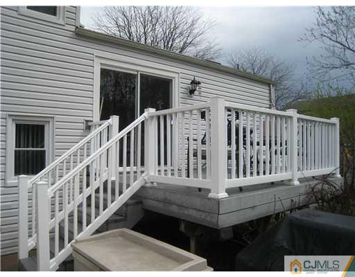 7 Butler Road Edison, NJ 08820 - Photo 17 of 18 a view of a house with wooden floor and a small yard