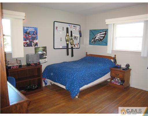 7 Butler Road Edison, NJ 08820 - Photo 10 of 18 a bed room with a bed and a television