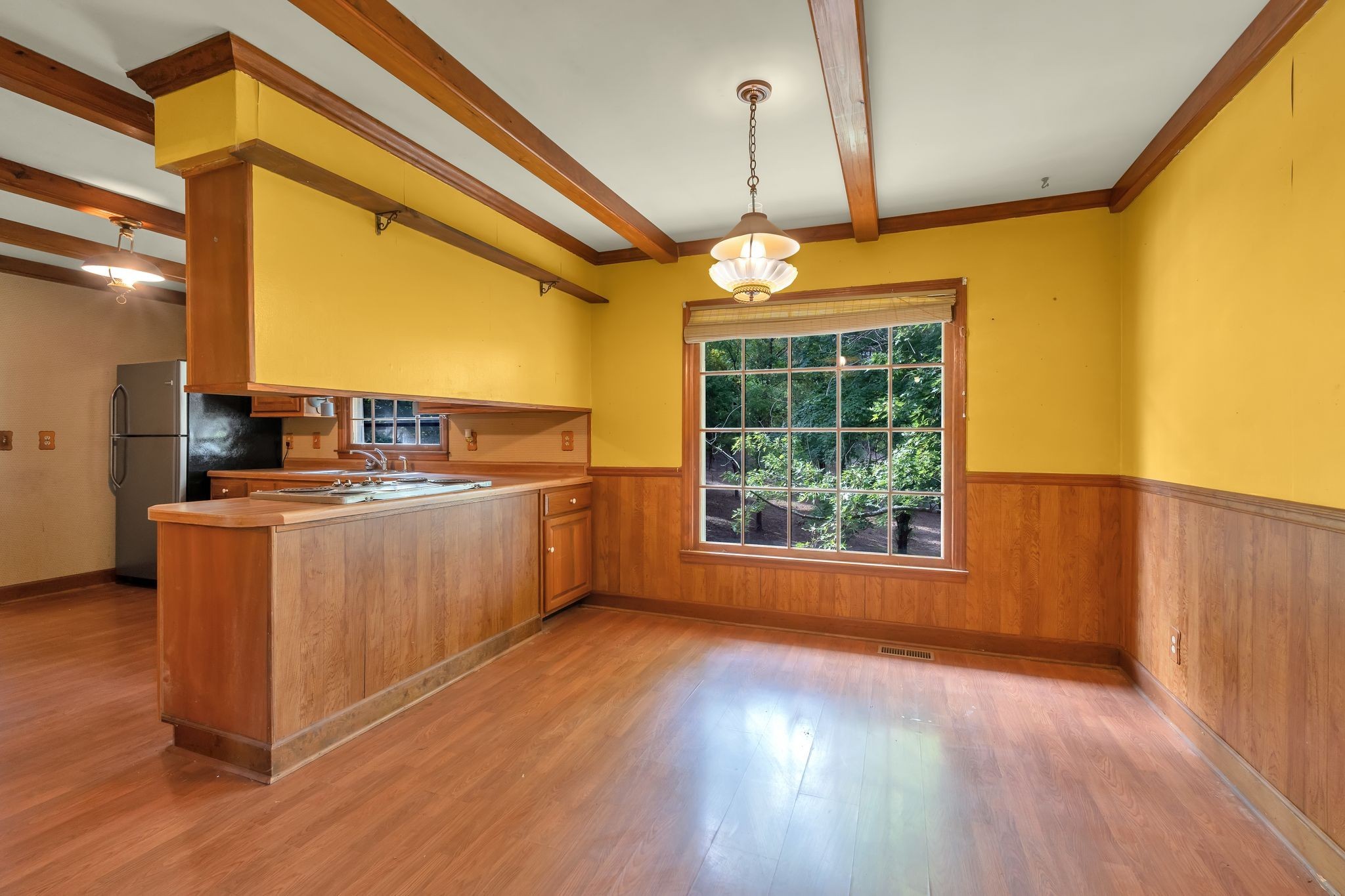 3406 Old Franklin Road Antioch, TN 37013 - Photo 11 of 50 a room with kitchen island a large window cabinets and stainless steel appliances