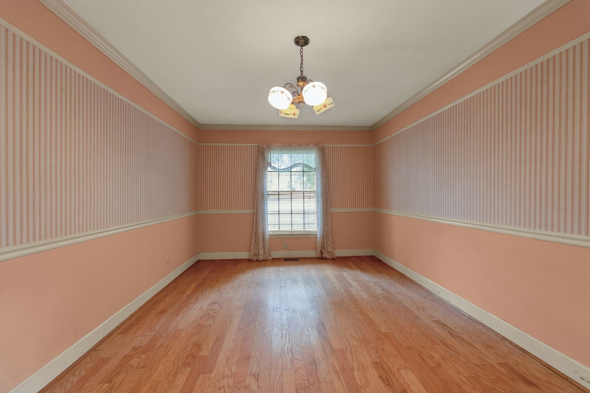 3406 Old Franklin Road Antioch, TN 37013 - Photo 20 of 50 an empty room with wooden floor chandelier and windows