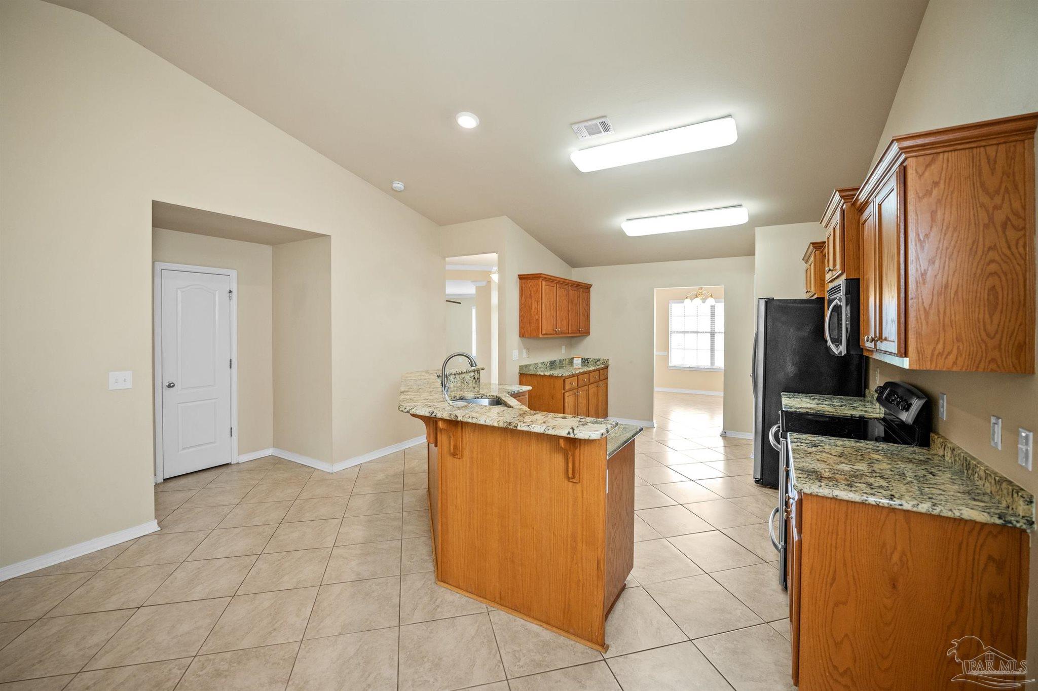 4574 Belvedere Circle Pace, FL 32571 - Photo 28 of 59 a kitchen with stainless steel appliances granite countertop a sink and a refrigerator