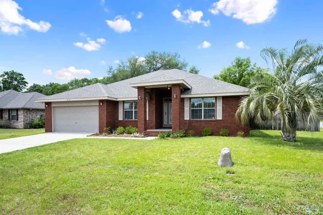 a front view of a house with a garden and yard