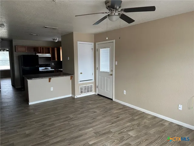 wooden floor in an empty room and a kitchen