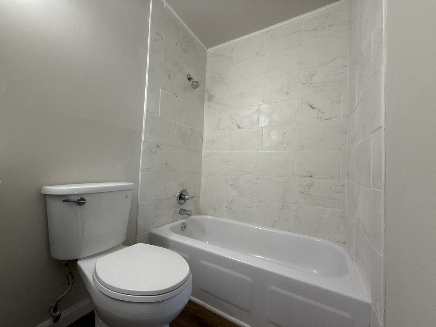 901 Gael Drive, Unit B Joliet, IL 60435 - Photo 13 of 17 a white toilet and tub sitting next to a bathroom sink