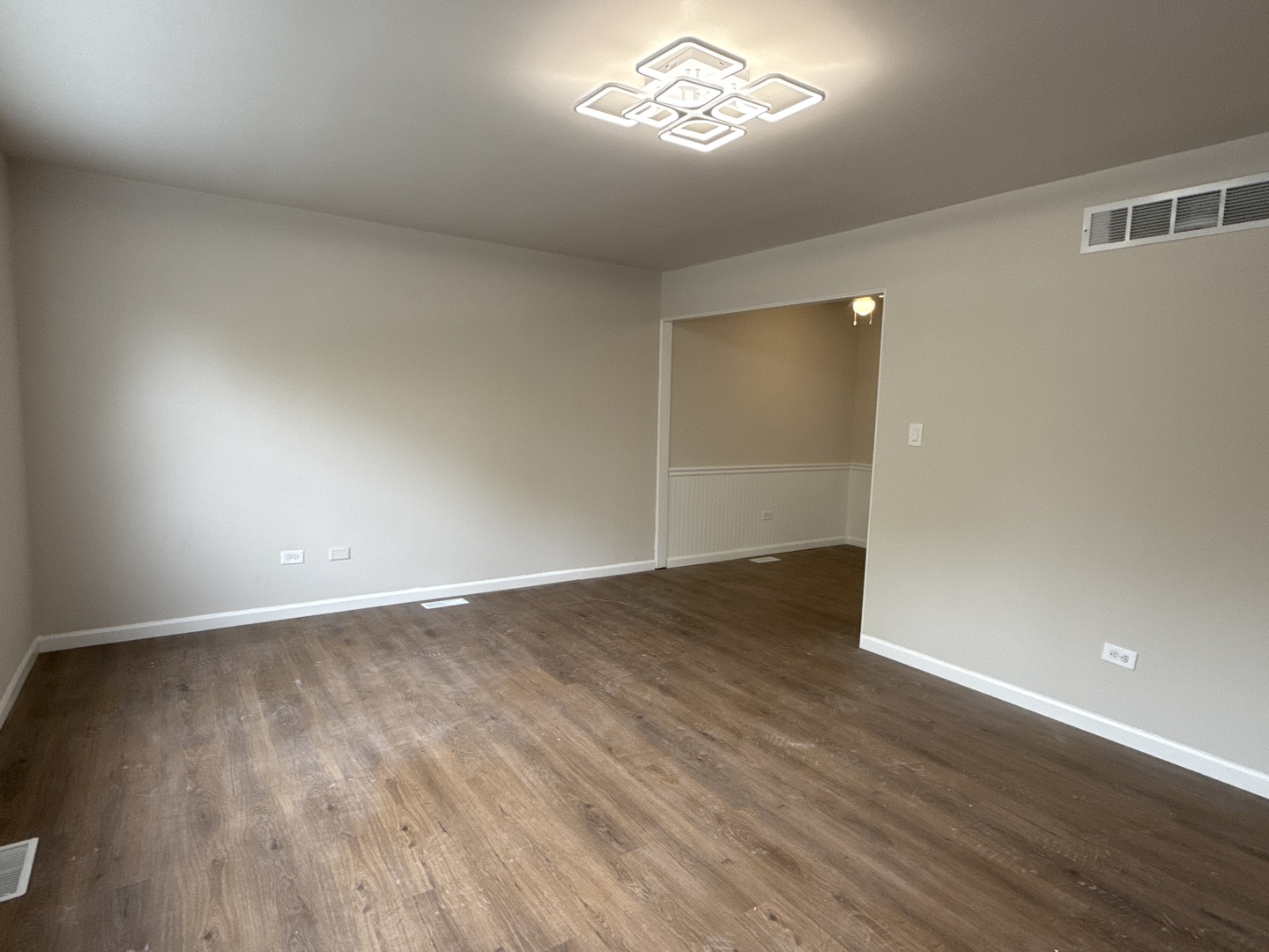 901 Gael Drive, Unit B Joliet, IL 60435 - Photo 4 of 17 an empty room with wooden floor and windows
