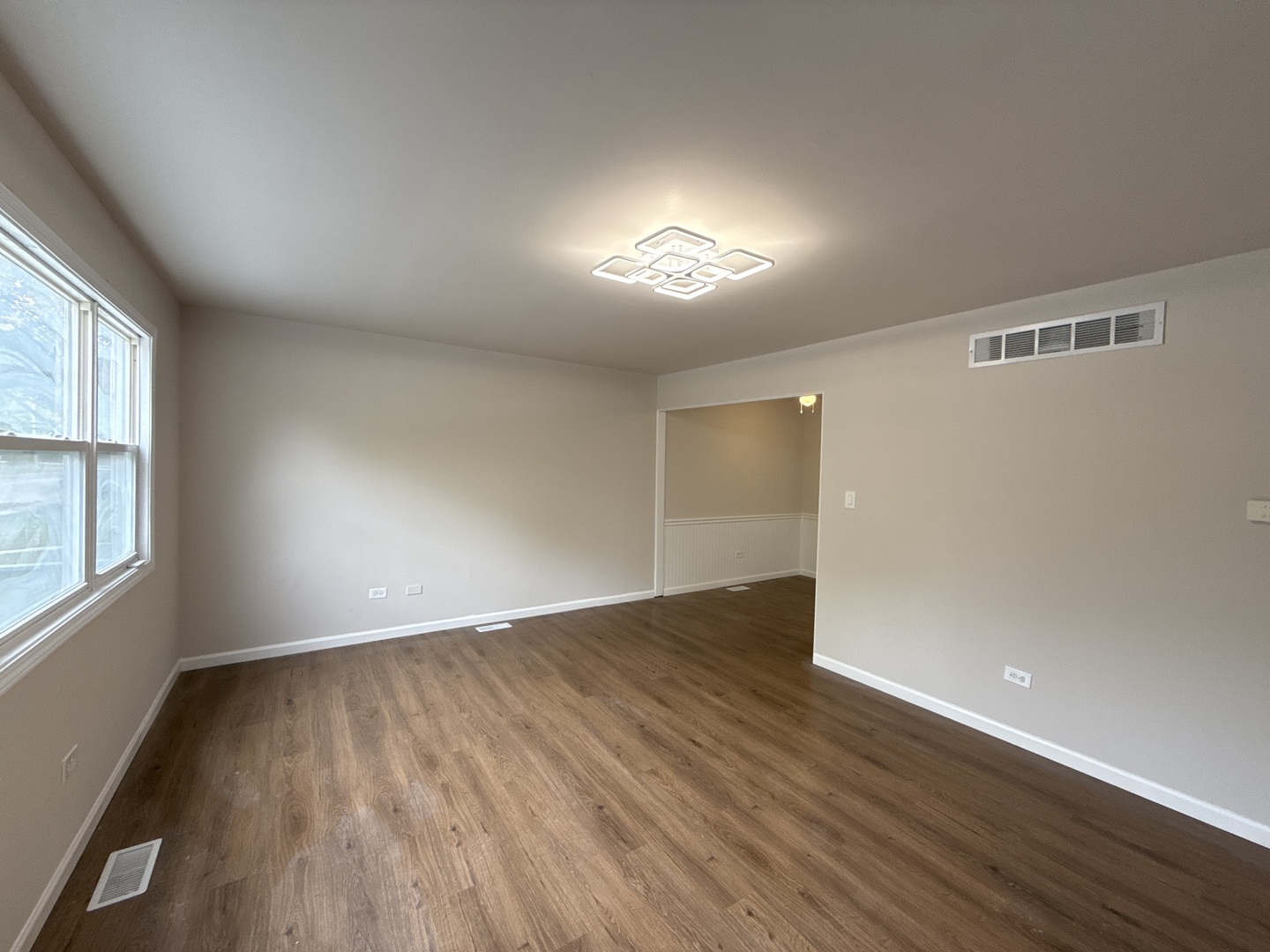 901 Gael Drive, Unit B Joliet, IL 60435 - Photo 5 of 17 an empty room with wooden floor and windows