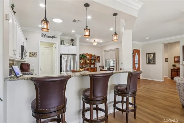 a kitchen with granite countertop a refrigerator stove top oven and sink