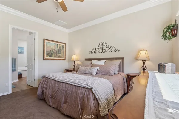 a bedroom with a bed and a lamp on table