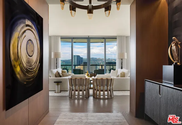 a living room with furniture and a floor to ceiling window