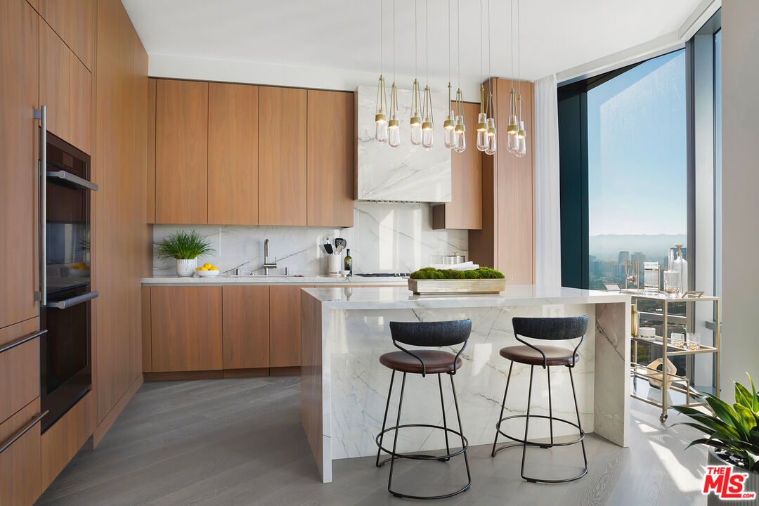 211 Elm Court, Unit 26C Los Angeles, CA 90067 - Photo 3 of 14 a kitchen with a refrigerator and cabinets