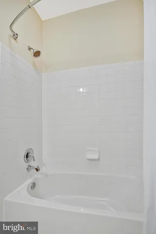 a bathroom with a granite countertop toilet sink and mirror