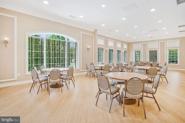 a kitchen with stainless steel appliances granite countertop a stove a sink dishwasher and cabinets with wooden floor