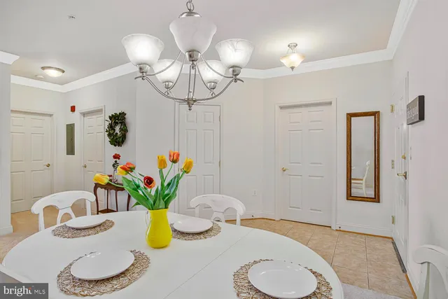 a view of a dining room with furniture and chandelier